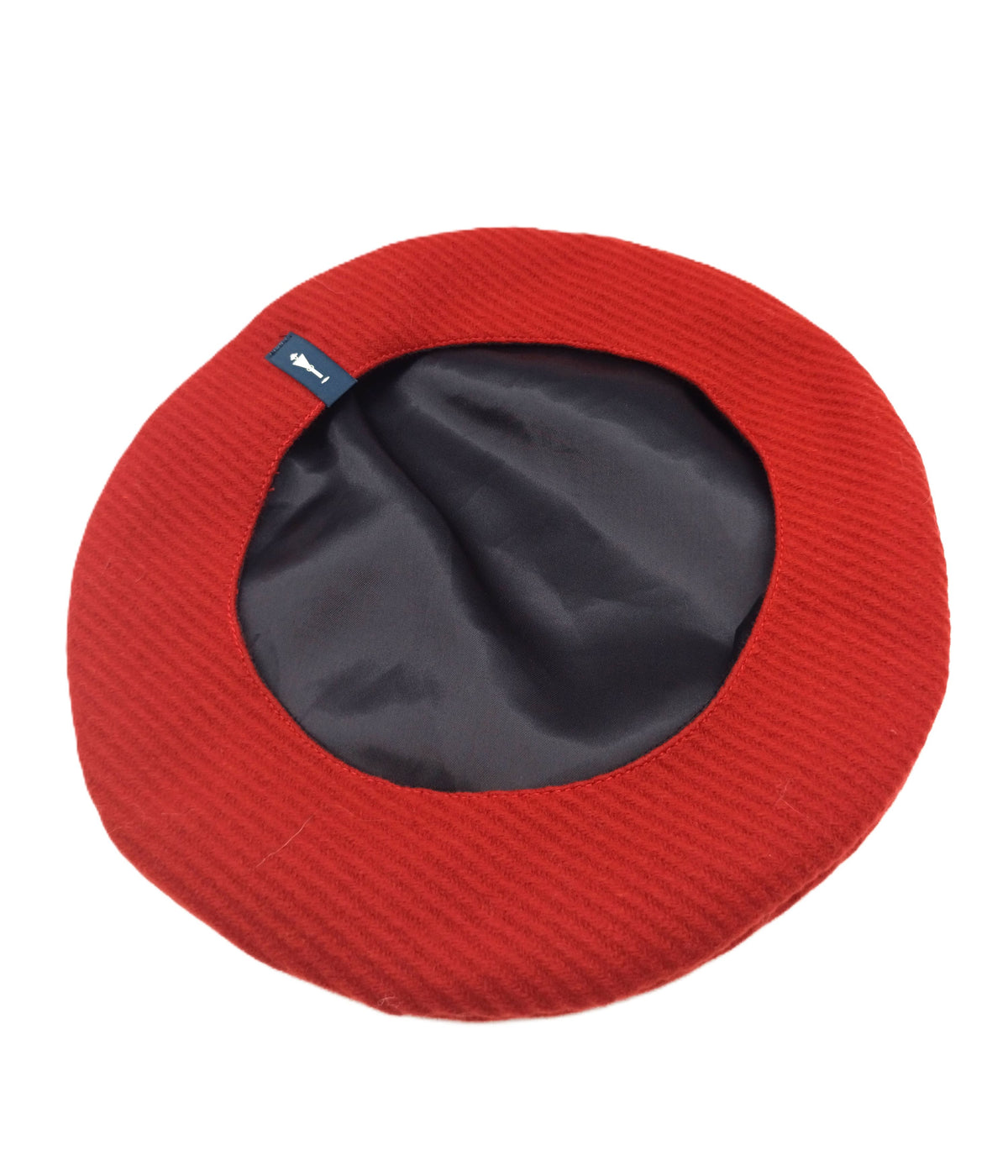 Basco in lana vergine color mattone del brand Accapofitto, visione della fodera interna nera