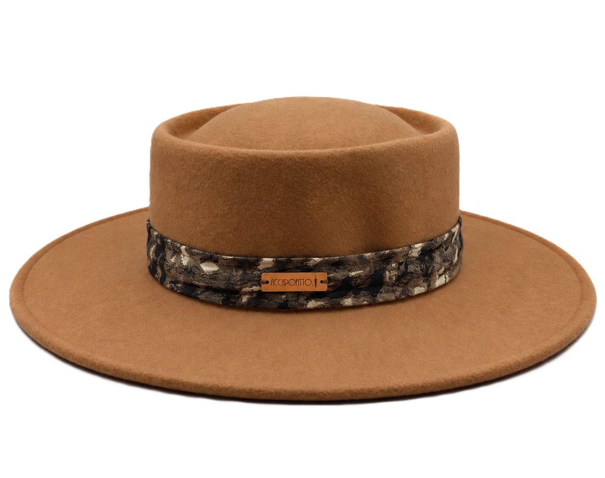 Cappello di feltro color cammello del brand Accapofitto, impreziosito da una fascia maculata sui toni del verde, nero e panna, con etichetta logo color rame