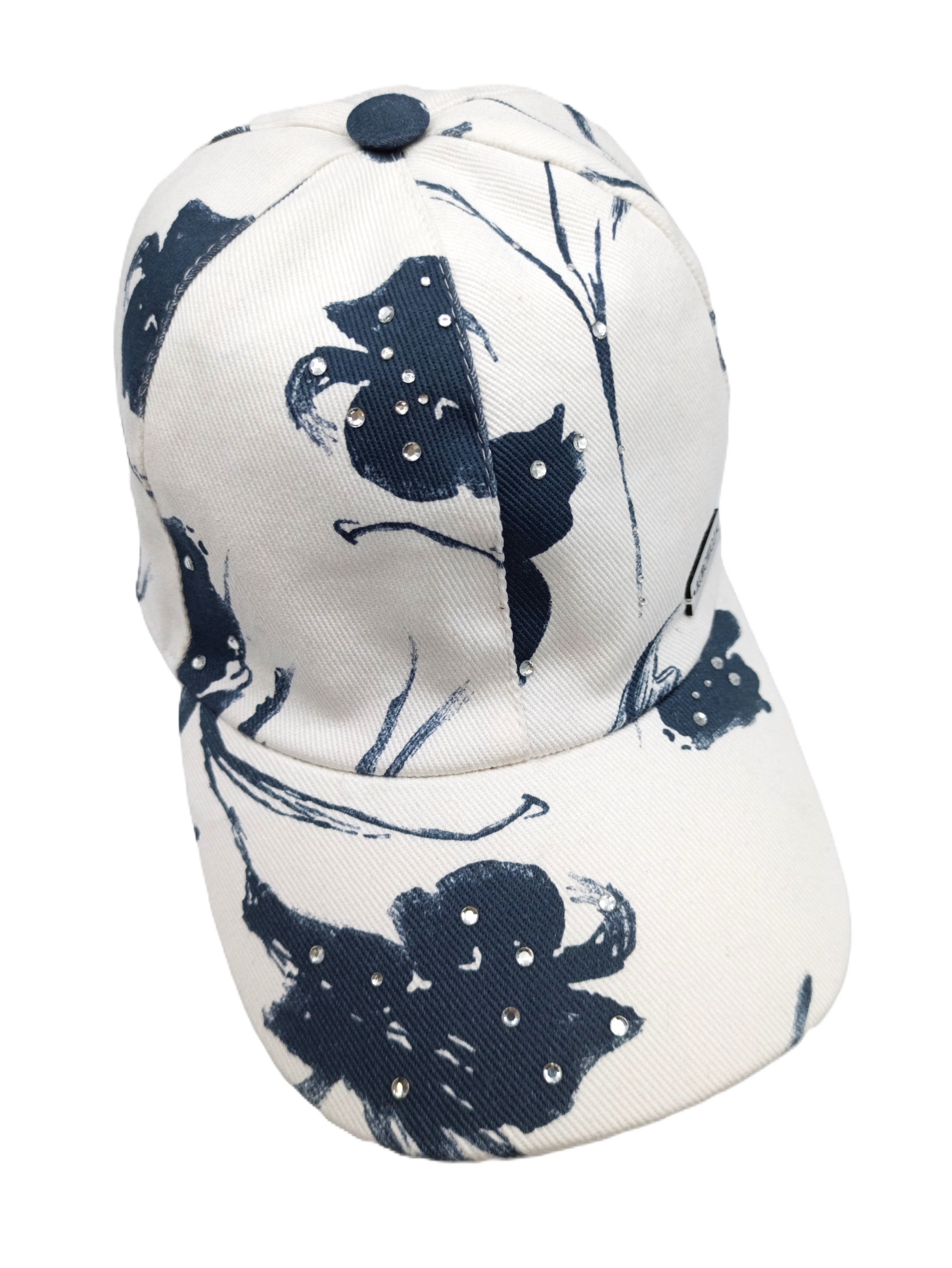 Cappello baseball del brand Accapofitto, in cotone bianco e disegno floreali blu, con strass. Visione dall'alto