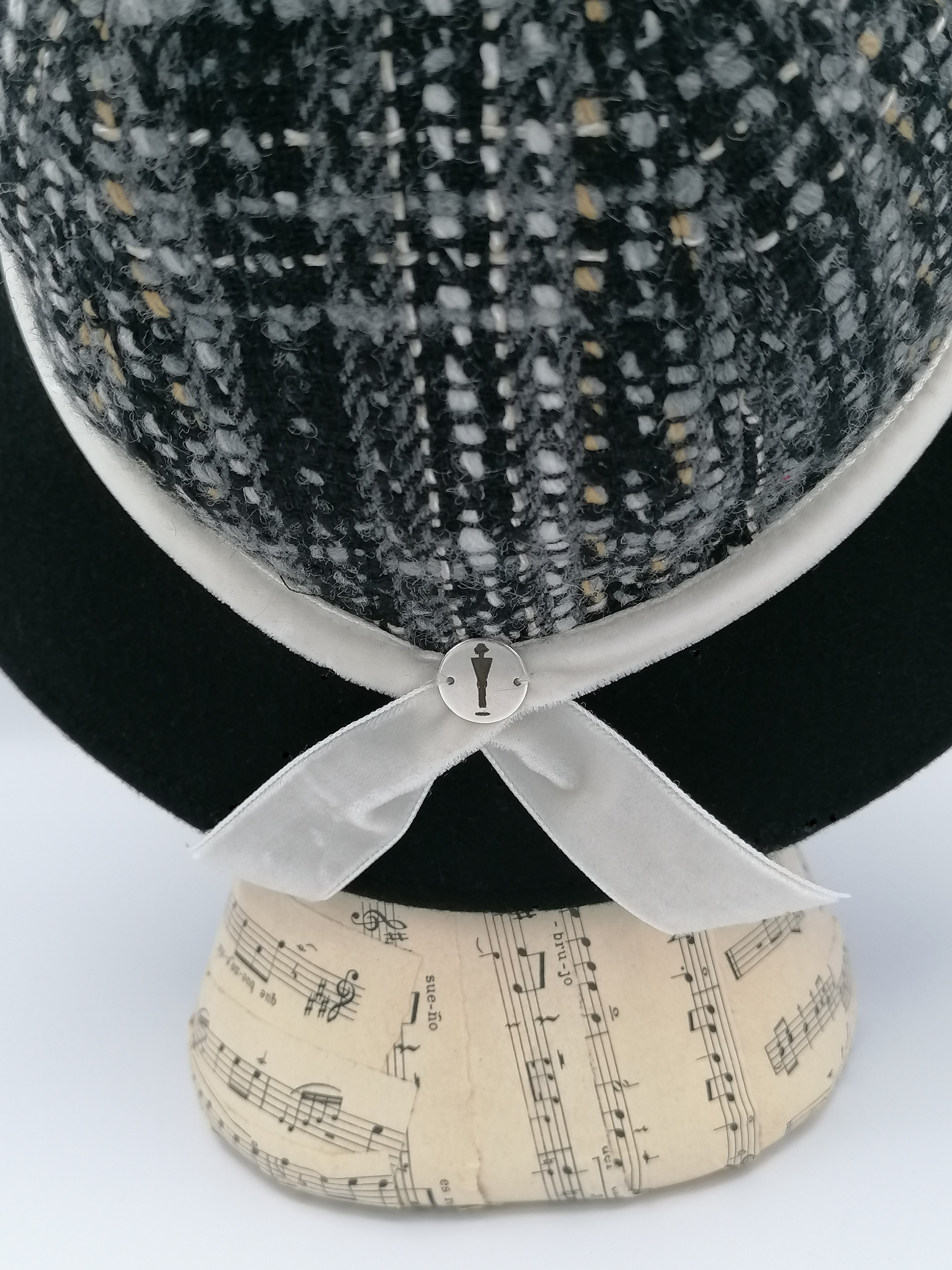 cappello donna modello cloche, tessuto lana fantasia, tesa feltro nero, nastro velluto bianco, retro